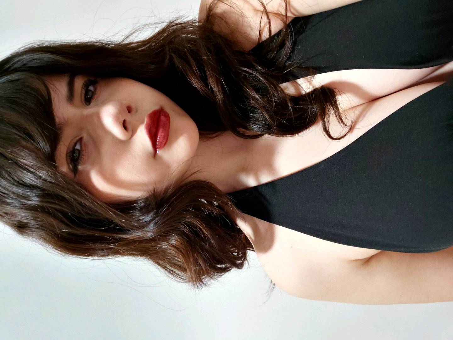 Woman with red lips in a black dress, online girl preview