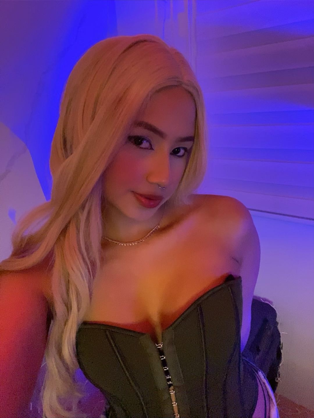 Woman facing the camera in colored indoor light for a video-chat setup guide